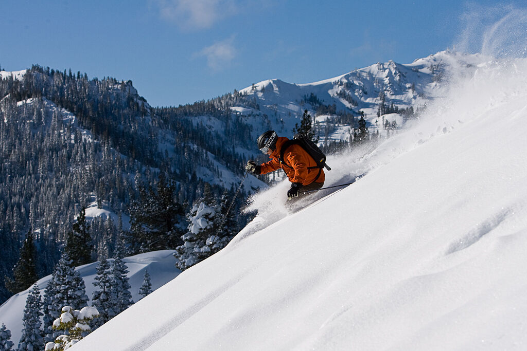 man skiing down slope